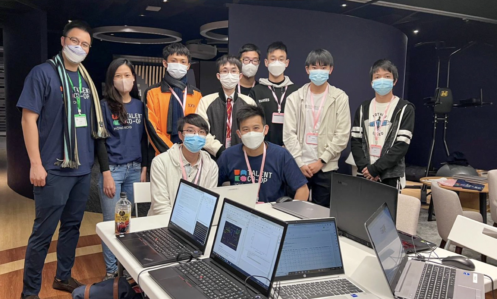Student hackathon group working on laptops